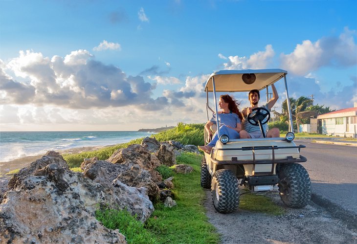 Driving a golf cart along the beach on Isla Mujeres
