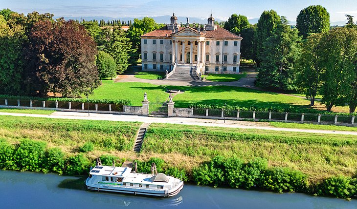 View of a cruise boat in front of the Villa Giovannelli Colonna on the Brenta Canal near Padua