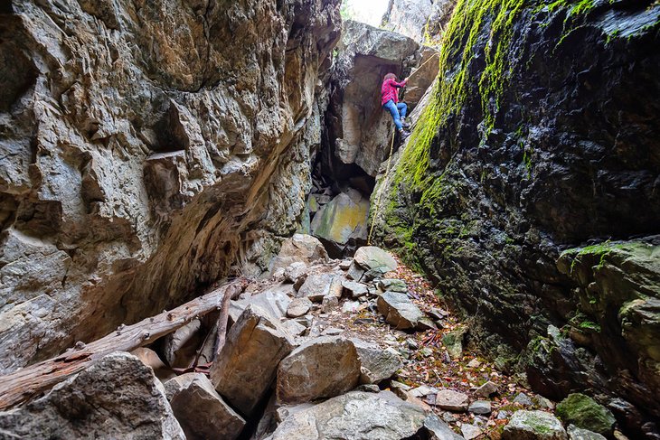 Climbing down a rocky cliff in Skaha Bluffs Provincial Park