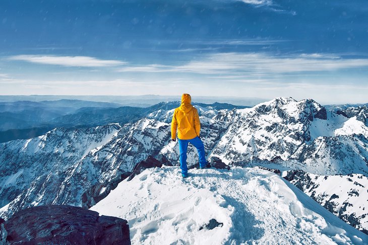 Climber atop Jebel Toubkal's snow covered summit