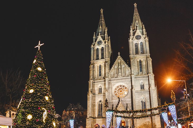 Christmas market in Namesti Miru Square with the St. Ludmila Church behind