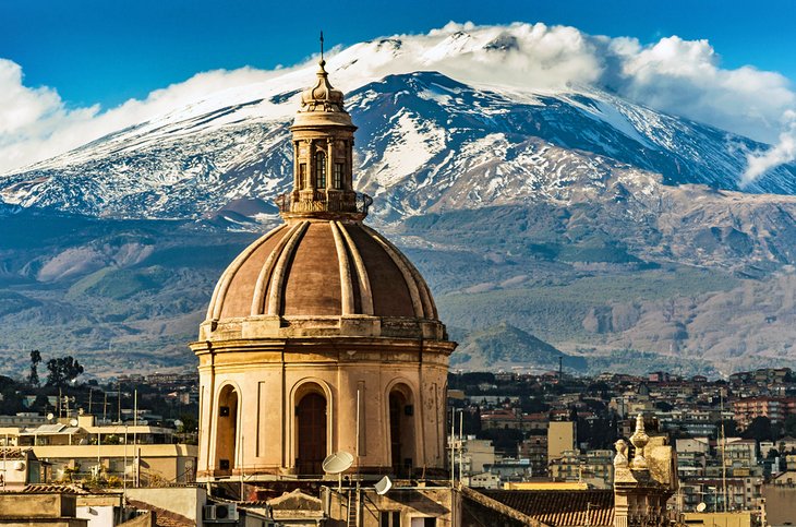 Catania Cathedral with snowcapped Mount Etna in the distance