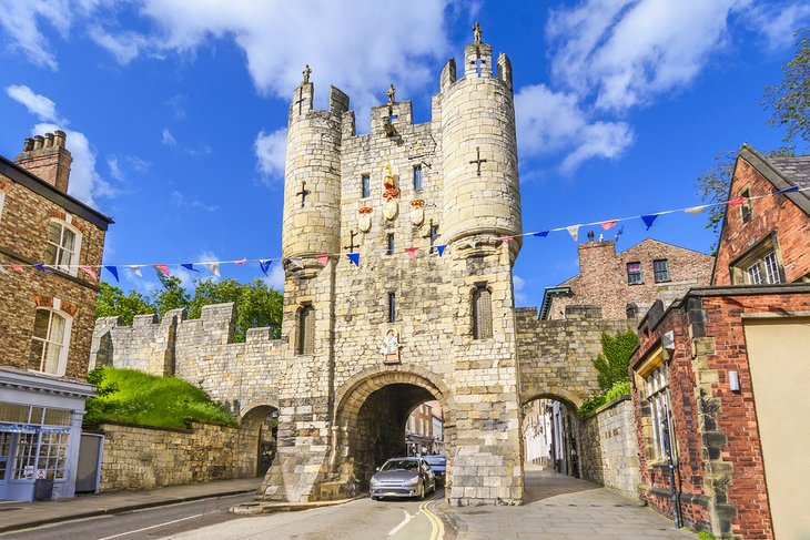 Cars driving through Micklegate Bar, an old medieval gate in York
