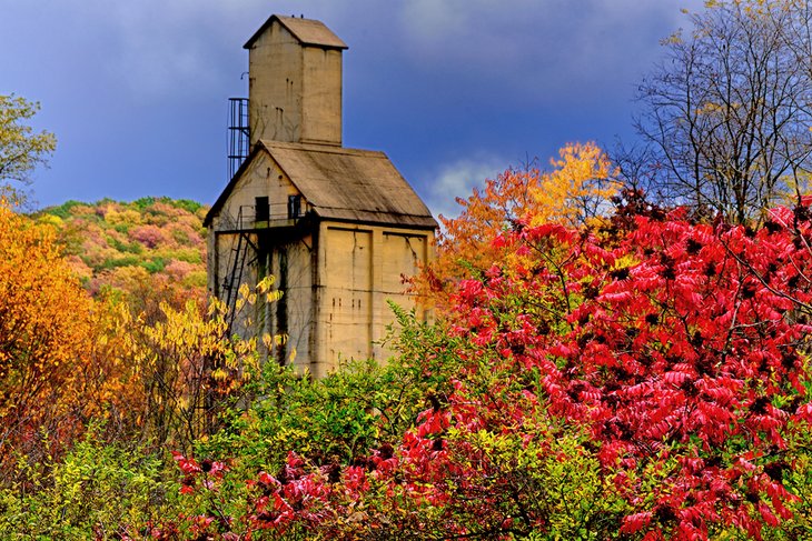 Abandoned train yard tower surrounded by fall colors in West Virginia