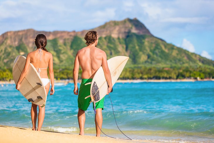 Surfers on Waikiki Beach with Diamond Head in the background