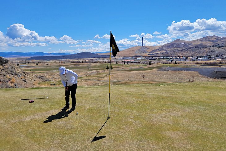 Golfing at Old Works with the smelter stack in the background