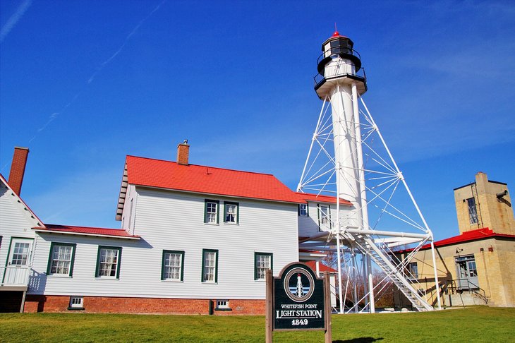 Whitefish Point Light Tower next to the Great Lakes Shipwreck Museum