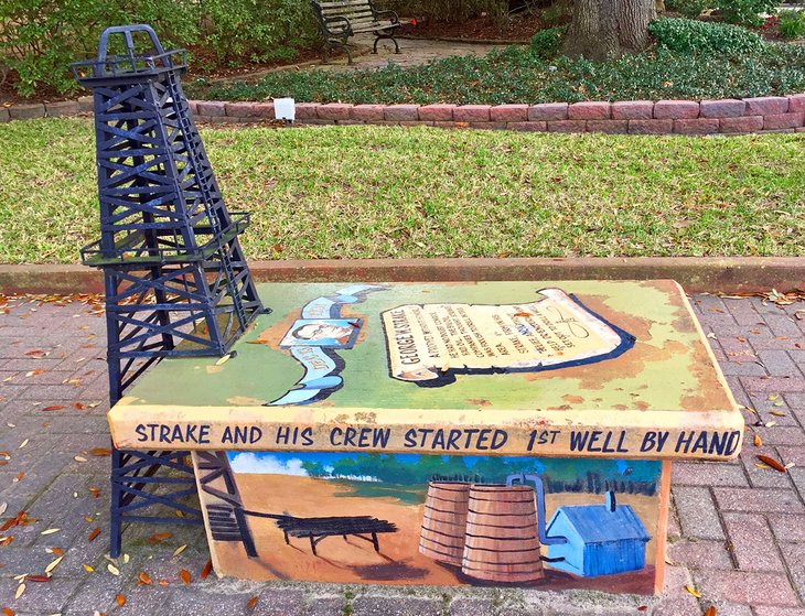 Downtown bench with Conroe's oil history