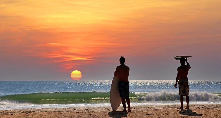 Surfers on Cocoa Beach at sunset