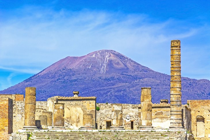 Temple ruins at Pompeii with Mount Vesuvius in the background