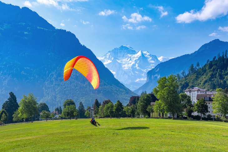 Paraglider landing at Hohematte Park in Interlaken