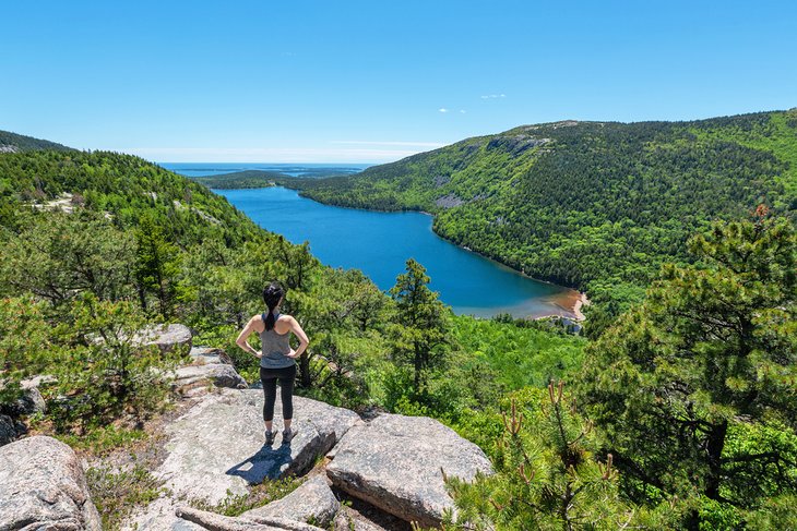 Hiker overlooking Jordan Pond at Acadia National Park