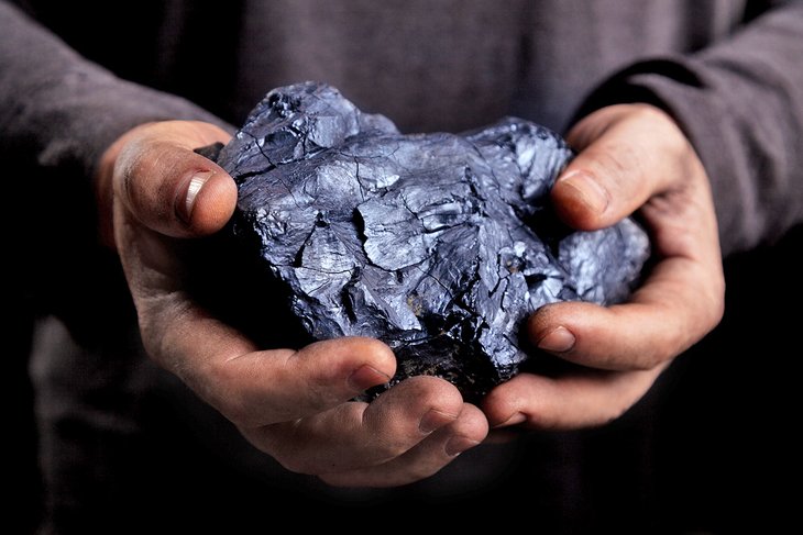 Miner holding coal