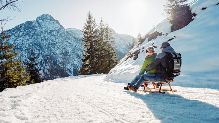 Couple tobogganing in Austria