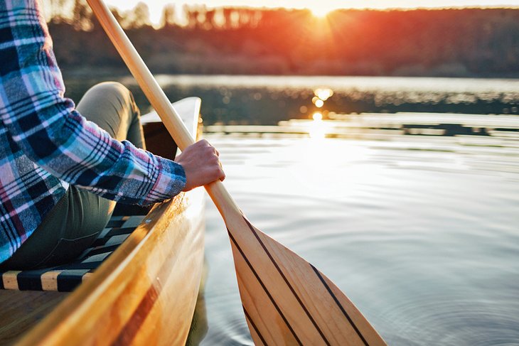 Paddling a canoe at sunset