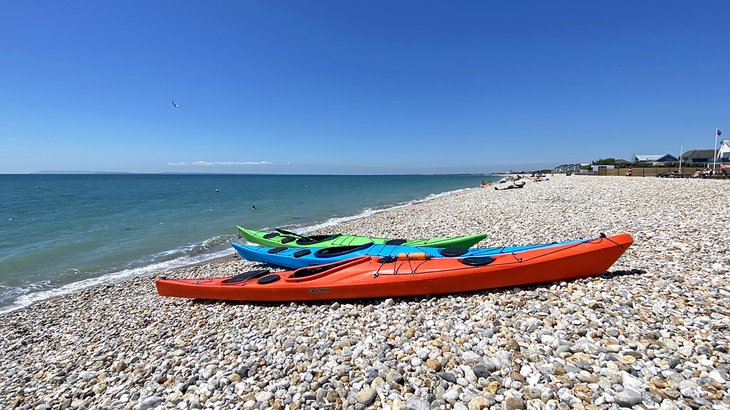 Colorful kayaks on the beach at Bracklesham Bay