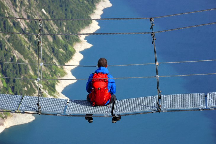 Hiker on a suspension bridge in the Zillertal Valley