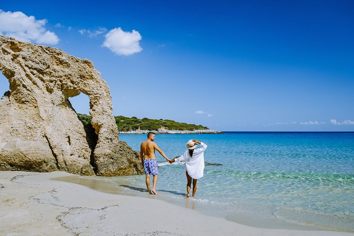 Couple walking on Voulisma Beach, Crete