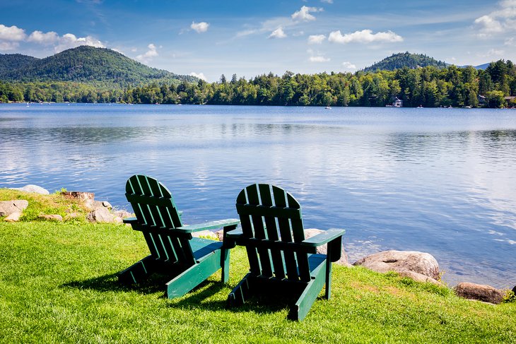 Adirondack chairs looking over Mirror Lake in Lake Placid