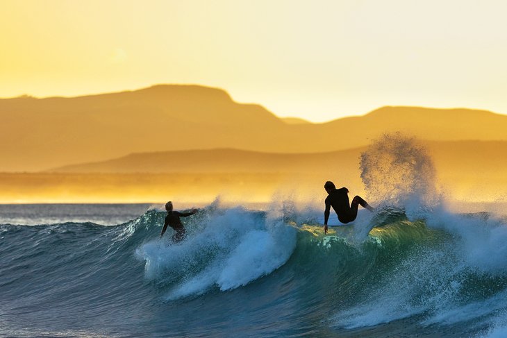 Surfers enjoying Supertubes at sunrise