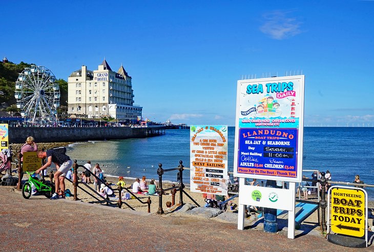 Boat trip signs on the Llandudno promenade