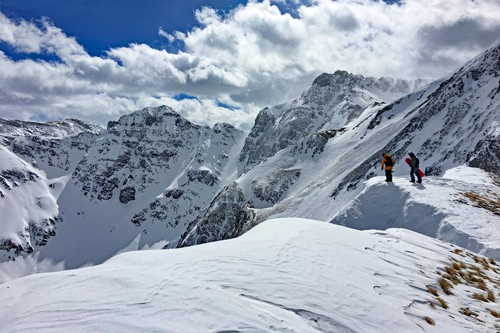 Snowboarders checking the expert terrain at Silverton Mountain