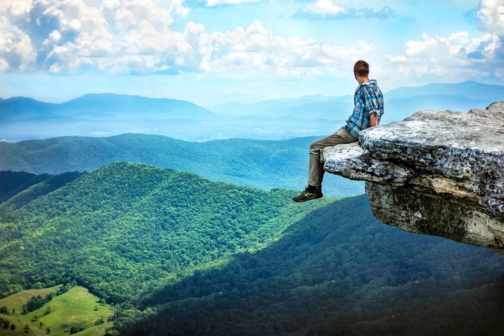 Hiker enjoying the view from McAfee Knob along the Appalachian Trail