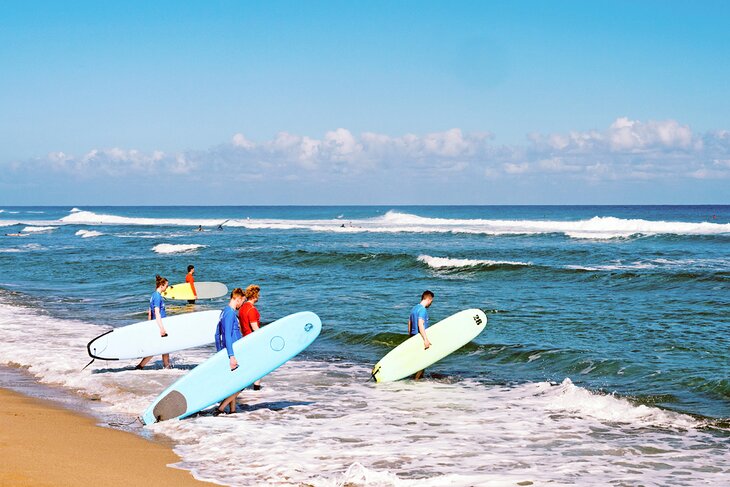 Teenagers going surfing in Hawaii