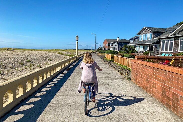 Woman biking along the Seaside Promenade