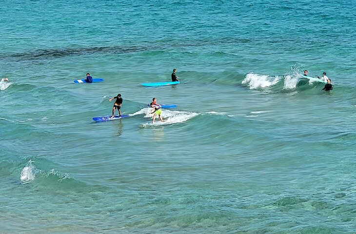Kids surfing on a beach in Parque Natural Corralejo