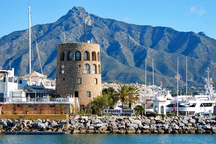 Round control tower overlooking Puerto Banús