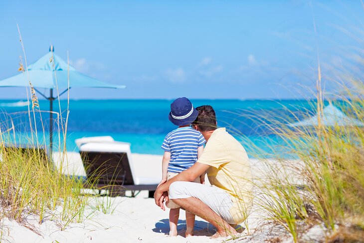 Father and son enjoying the beautiful beach in the Turks & Caicos
