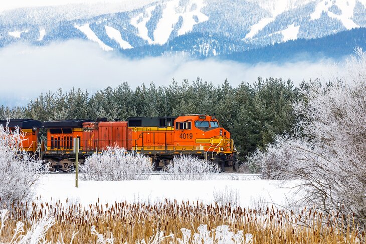 A locomotive going past Whitefish Mountain Resort