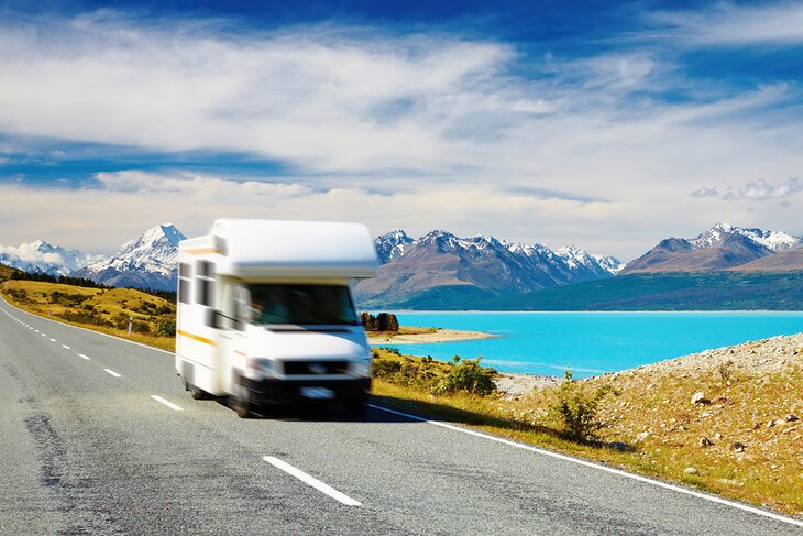 Campervan passing in front of Mount Cook