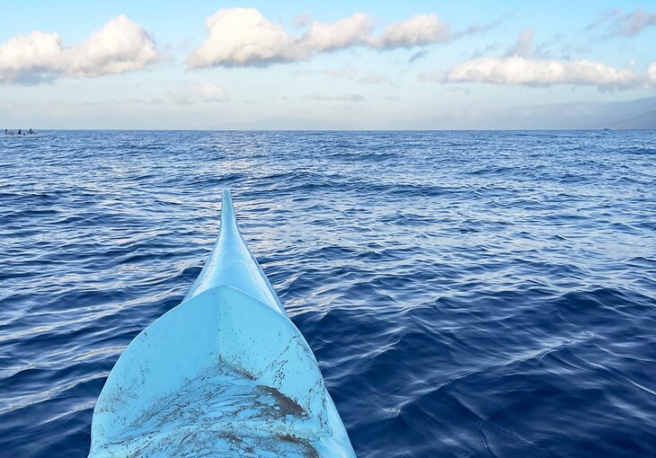 The hull of an outrigger canoe on the water